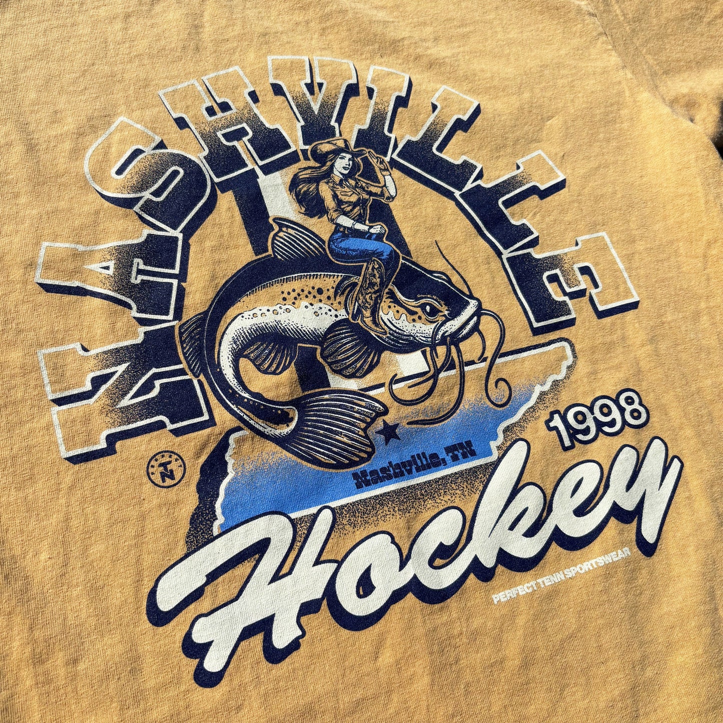 Nashville Hockey Mustard Yellow Catfish Rodeo Tee